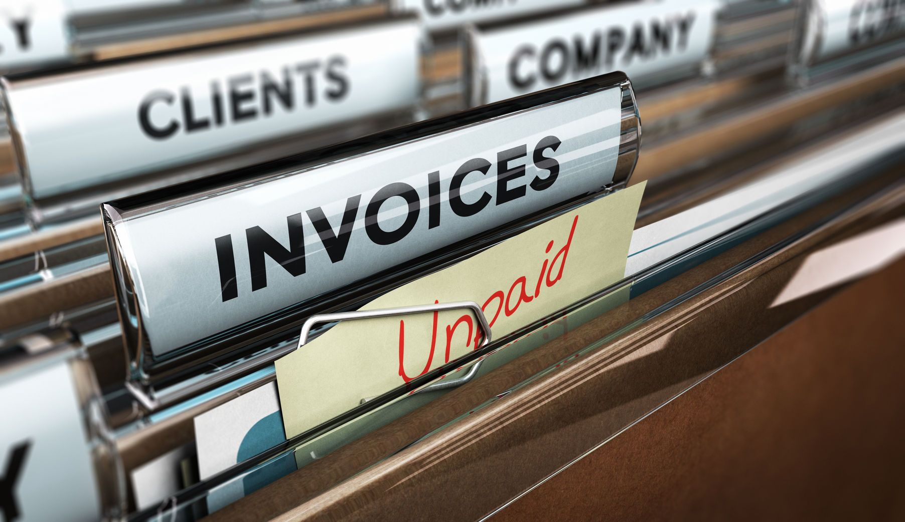 debt4 48467259 - close up on a file tab with the word invoice and a note where it is handwritten unpaid with blur effect. concept image for illustration of unpaid invoices recovery.